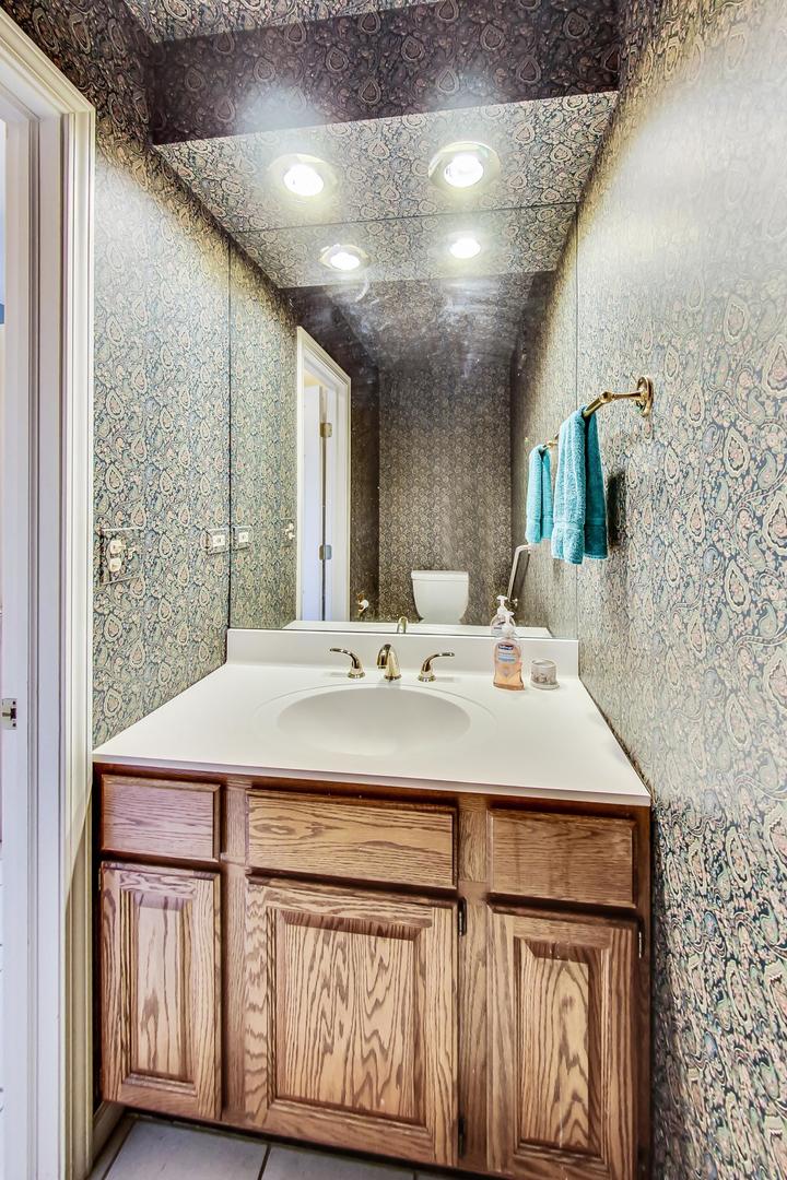 2813 Meyers Road Oak Brook, IL 60523 - Photo 28 of 62 a bathroom with a sink a vanity and a mirror