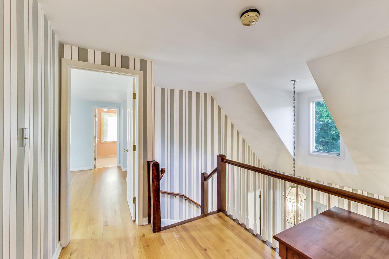 2813 Meyers Road Oak Brook, IL 60523 - Photo 31 of 62 a view of a hallway with wooden floor and stairs