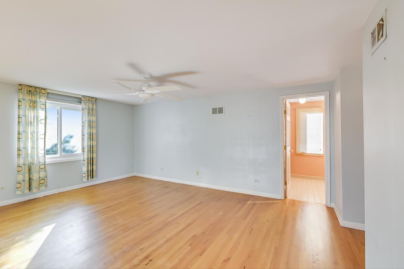 2813 Meyers Road Oak Brook, IL 60523 - Photo 32 of 62 a view of an empty room with wooden floor and a window