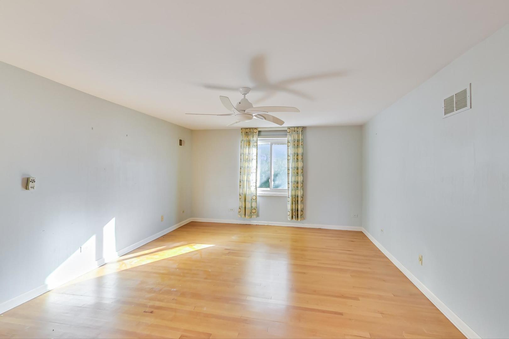 2813 Meyers Road Oak Brook, IL 60523 - Photo 33 of 62 a view of an empty room with window and wooden floor