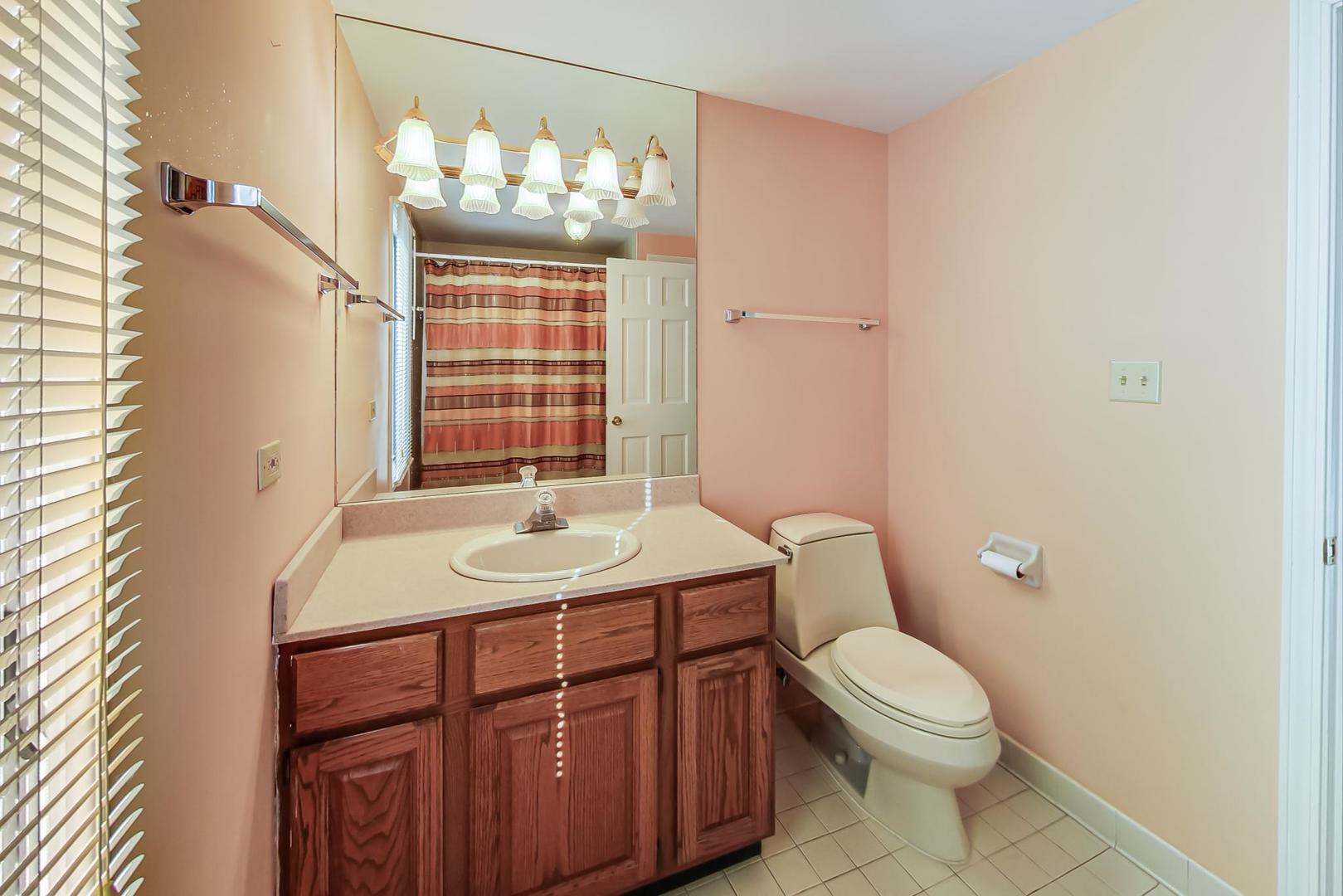 2813 Meyers Road Oak Brook, IL 60523 - Photo 36 of 62 a bathroom with a granite countertop sink toilet and mirror