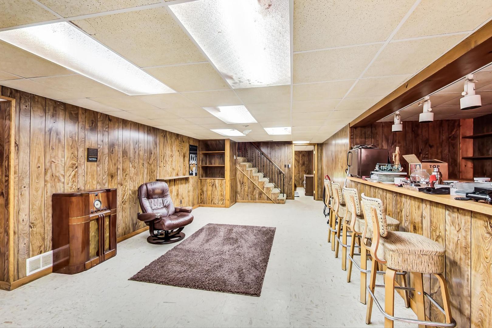 2813 Meyers Road Oak Brook, IL 60523 - Photo 47 of 62 a living room with furniture a large window and bookshelf