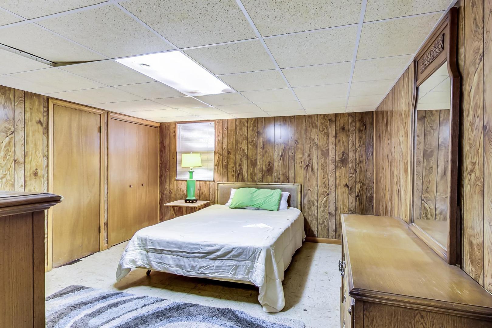 2813 Meyers Road Oak Brook, IL 60523 - Photo 52 of 62 a spacious bedroom with a bed and a dresser next to a window