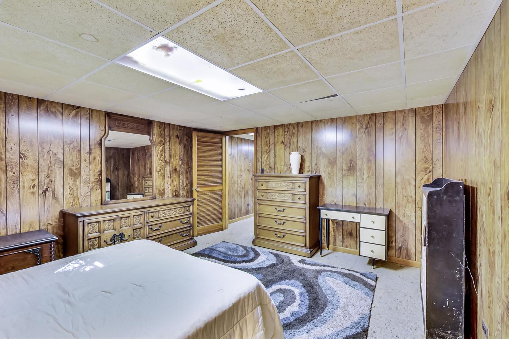 2813 Meyers Road Oak Brook, IL 60523 - Photo 53 of 62 a bedroom with a bed and dresser with mirror