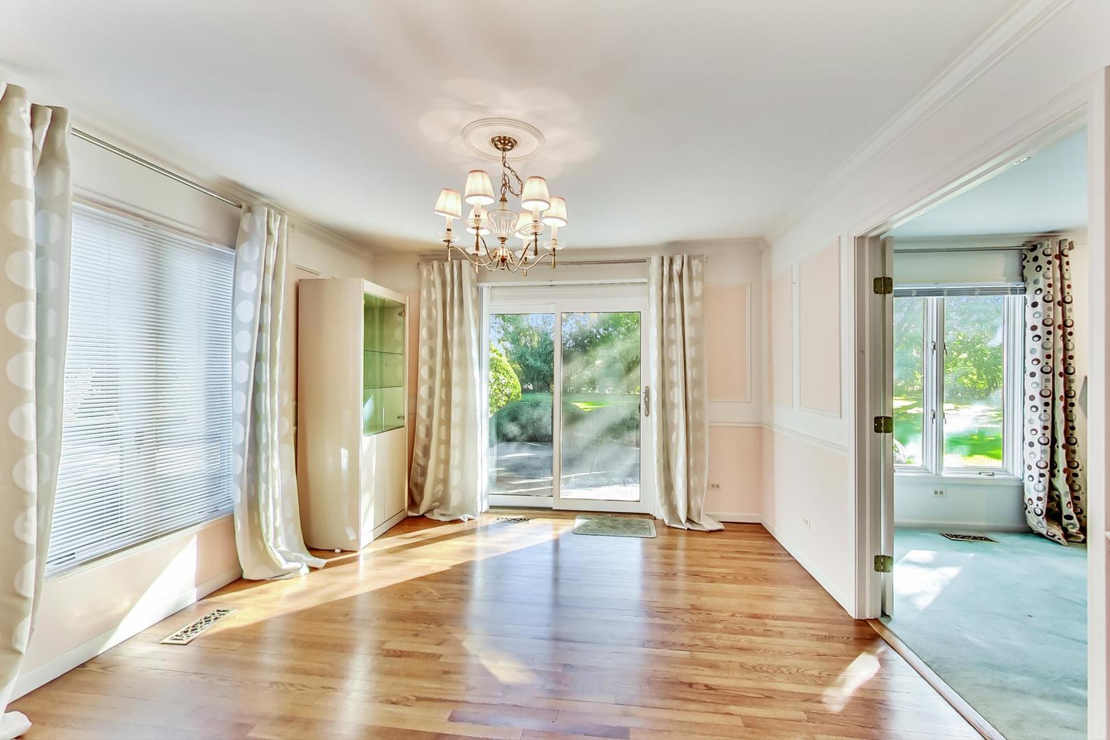 2813 Meyers Road Oak Brook, IL 60523 - Photo 9 of 62 a view of an empty room with wooden floor and a window