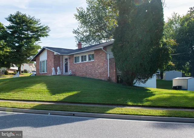 a view of house with garden space and trees
