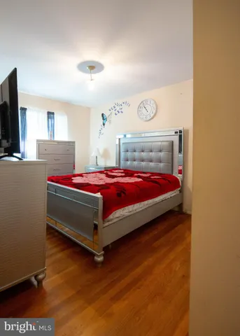 a bedroom with a bed and flat screen tv