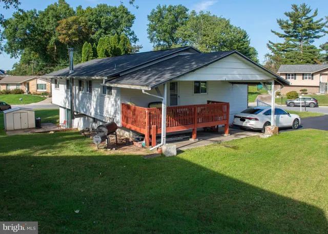 a view of a house with a yard and sitting area