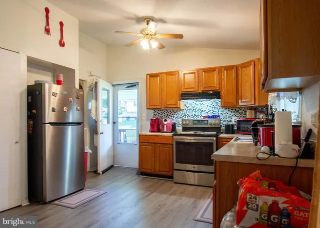 a kitchen with refrigerator and a stove