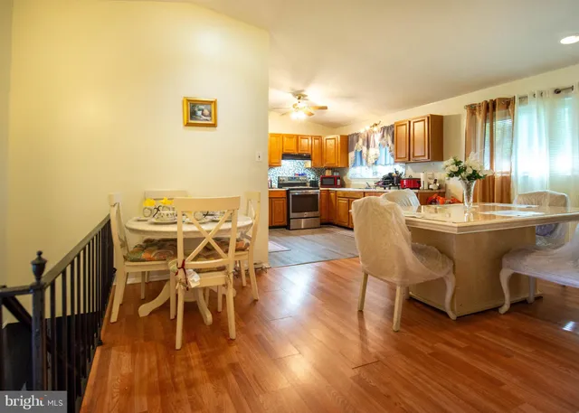 a dining room with furniture a rug and wooden floor