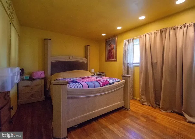 a bedroom with a bed and a mirror