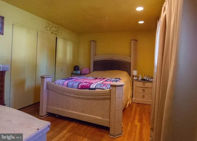a bedroom with a bed and a dresser