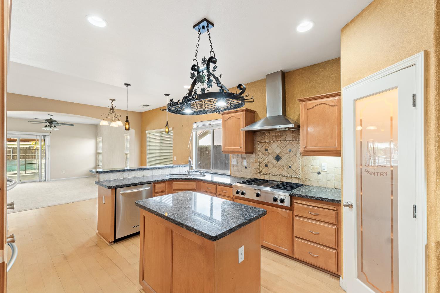 783 Bodega Avenue Lemoore, CA 93245 - Photo 11 of 35 a kitchen with stainless steel appliances granite countertop a sink a stove and a refrigerator