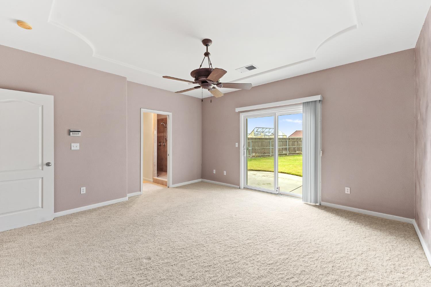 783 Bodega Avenue Lemoore, CA 93245 - Photo 18 of 35 a view of a bedroom with a ceiling fan and a window