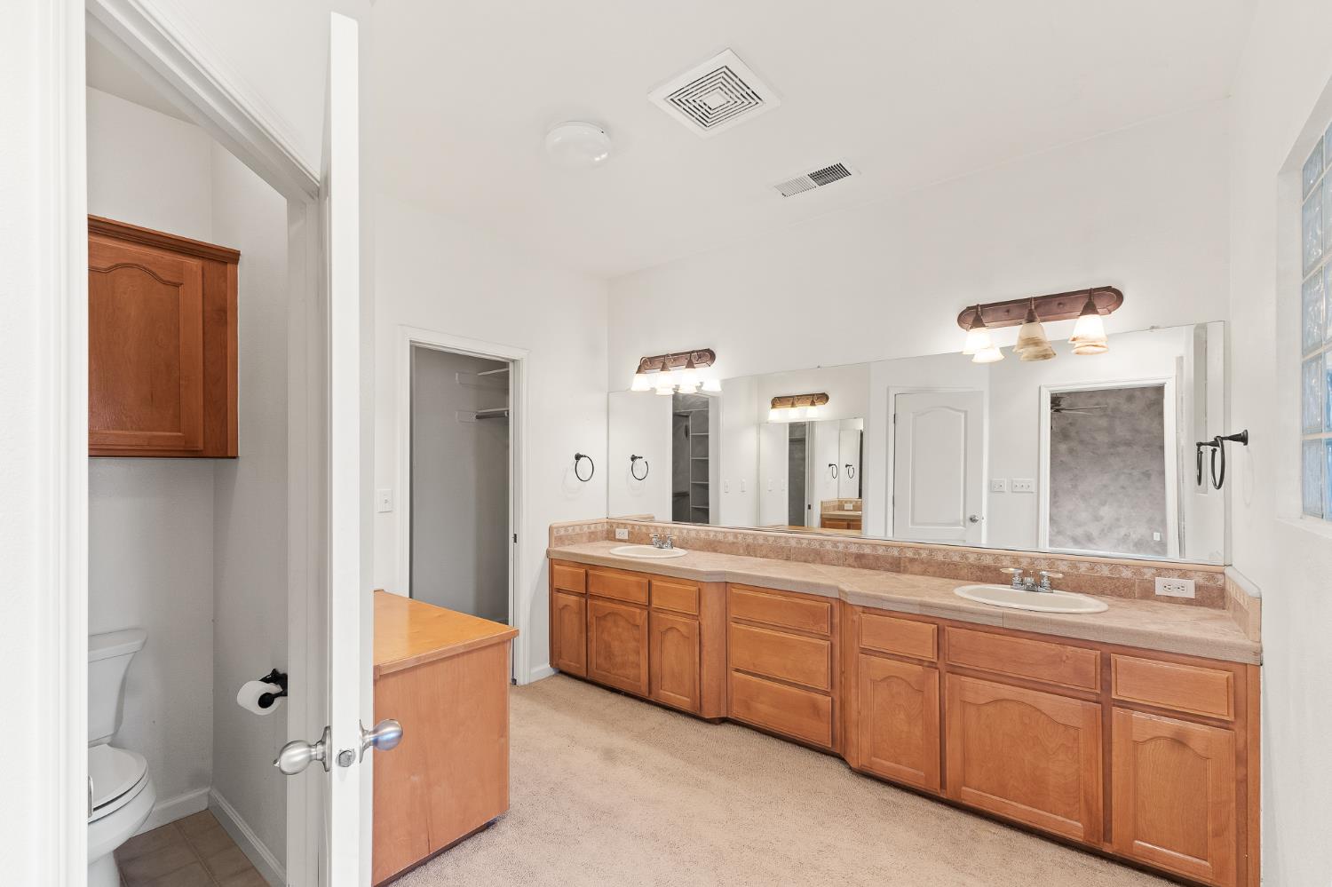 783 Bodega Avenue Lemoore, CA 93245 - Photo 22 of 35 a spacious bathroom with a double vanity sink a mirror and a bathtub
