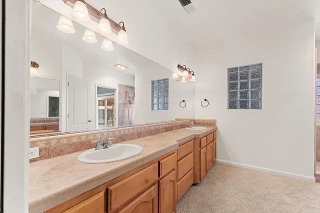 a bathroom with a granite countertop sink and a mirror