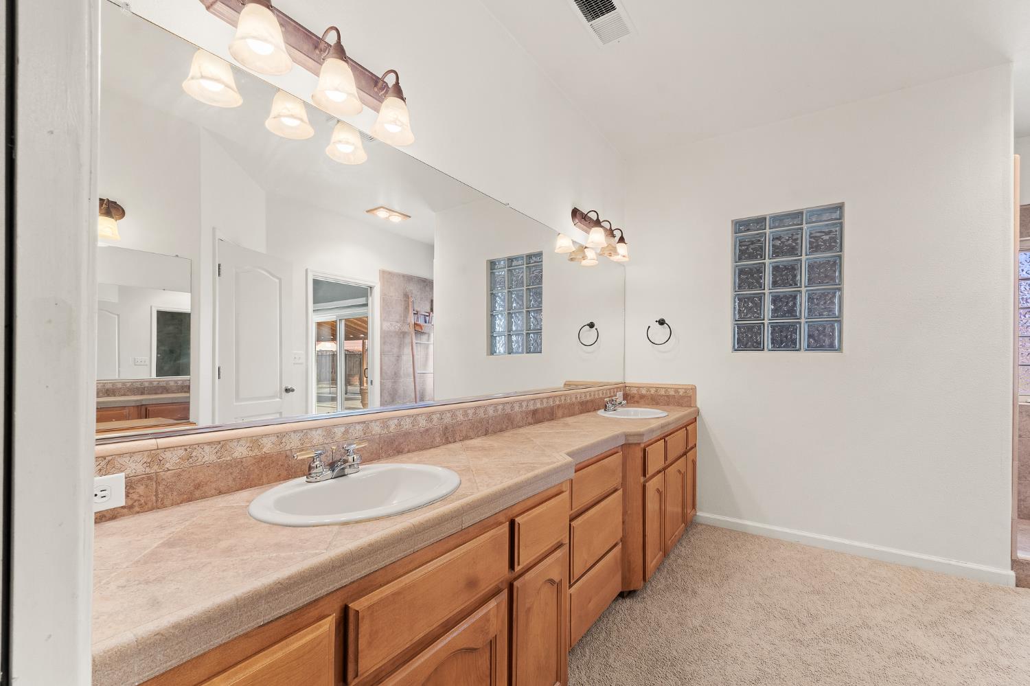 783 Bodega Avenue Lemoore, CA 93245 - Photo 23 of 35 a bathroom with a granite countertop sink and a mirror