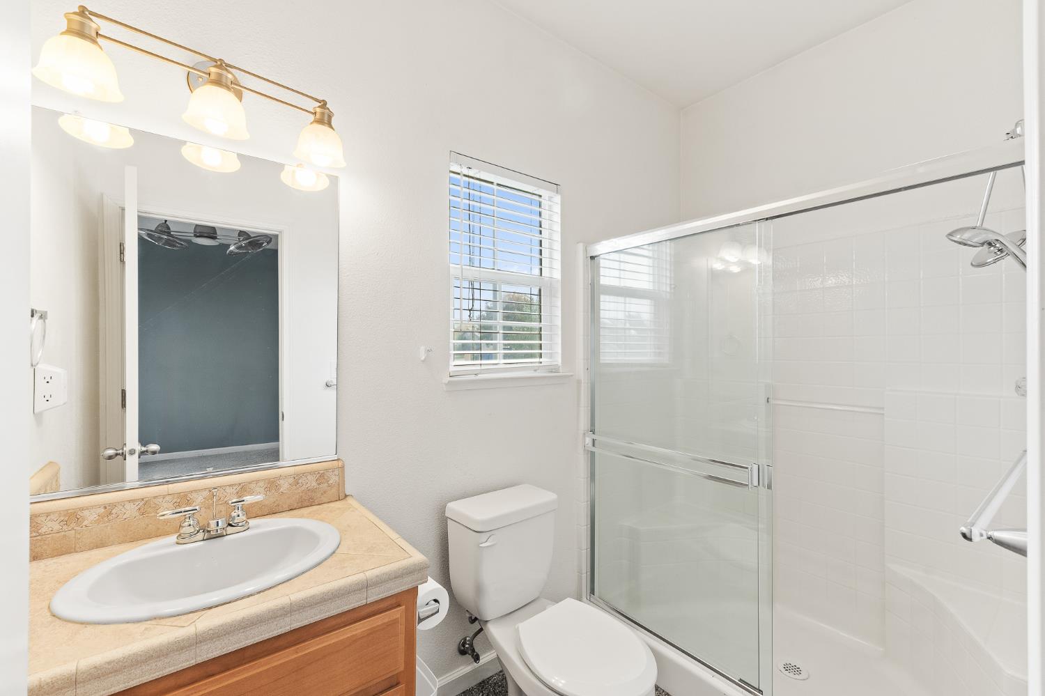 783 Bodega Avenue Lemoore, CA 93245 - Photo 26 of 35 a bathroom with a sink a toilet and shower