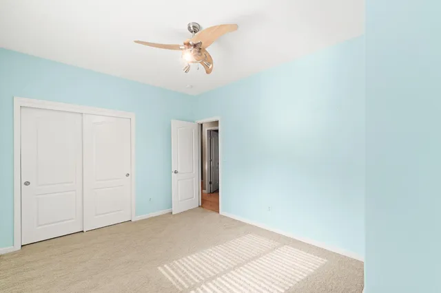a view of a room with a ceiling fan
