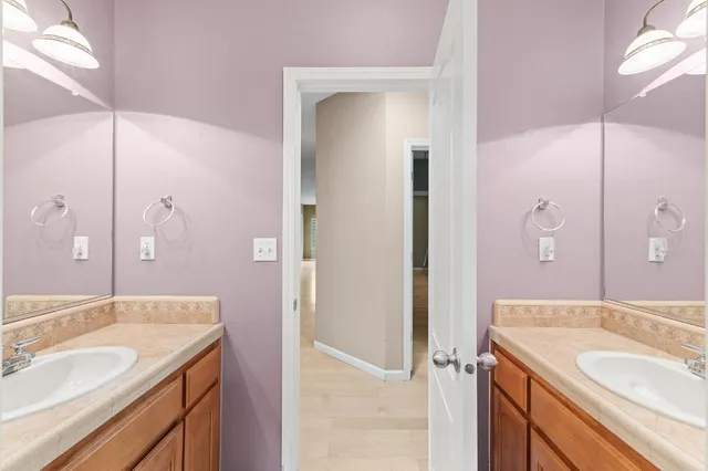 a bathroom with a granite countertop sink shower and a mirror
