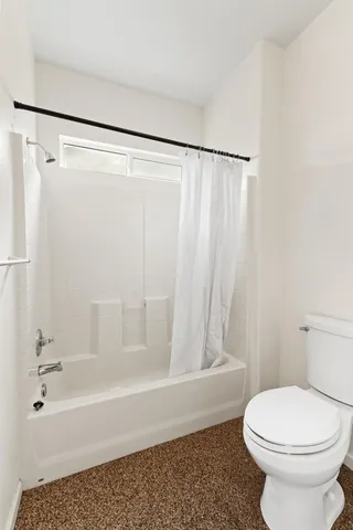 a bathroom with a toilet and a bathtub