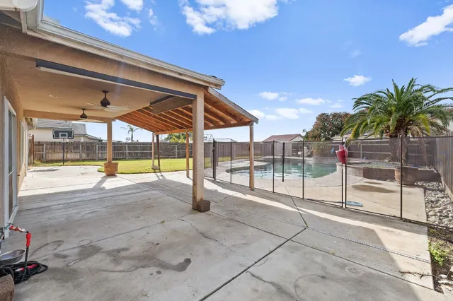 a view of swimming pool with outdoor seating and city view