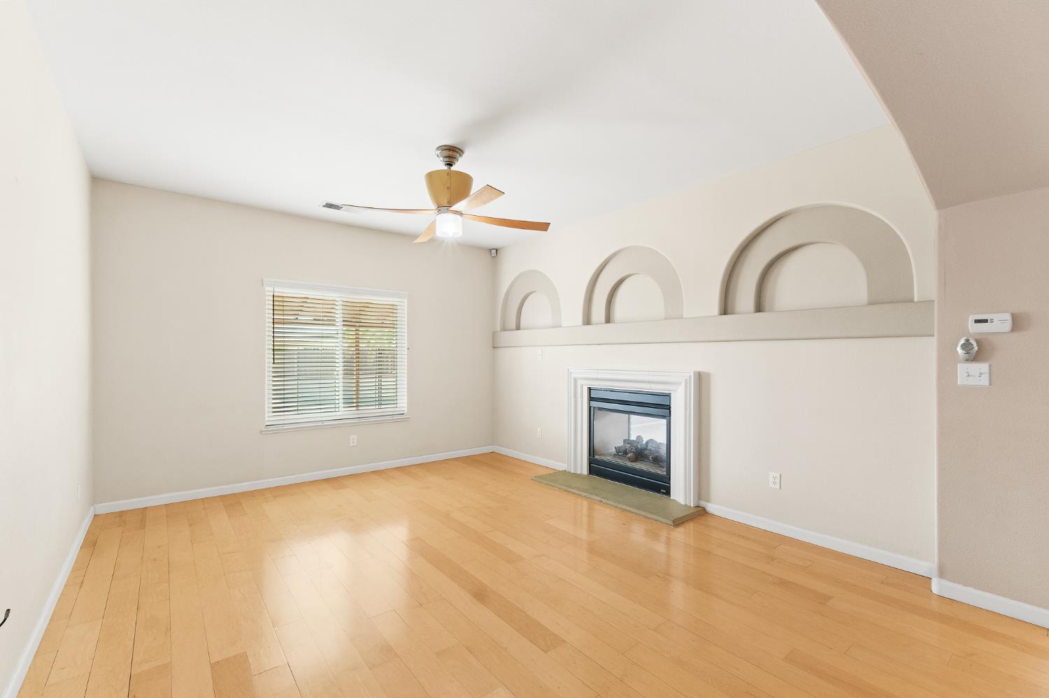 783 Bodega Avenue Lemoore, CA 93245 - Photo 6 of 35 a view of an empty room with a fireplace and a window