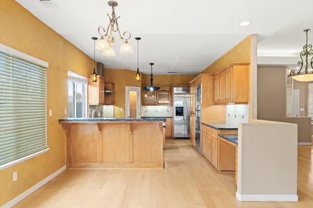 a view of kitchen with furniture and a chandelier