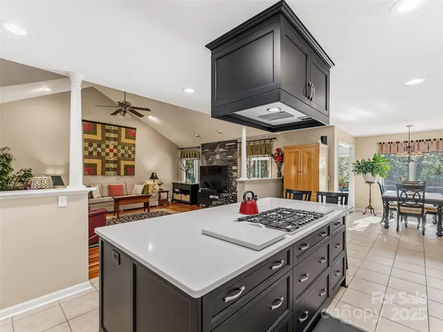 a kitchen with a stove a table and chairs in it