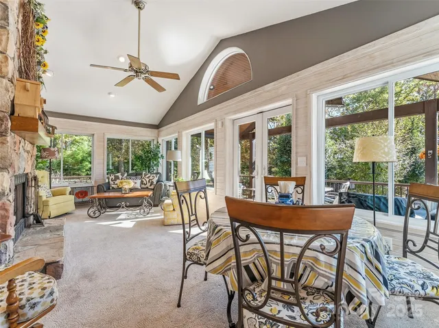 a dining room with furniture a chandelier and a rug