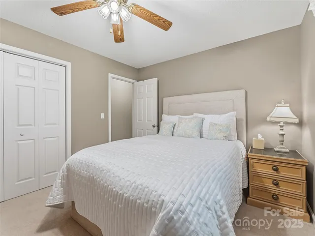 a bedroom with a bed and cabinet