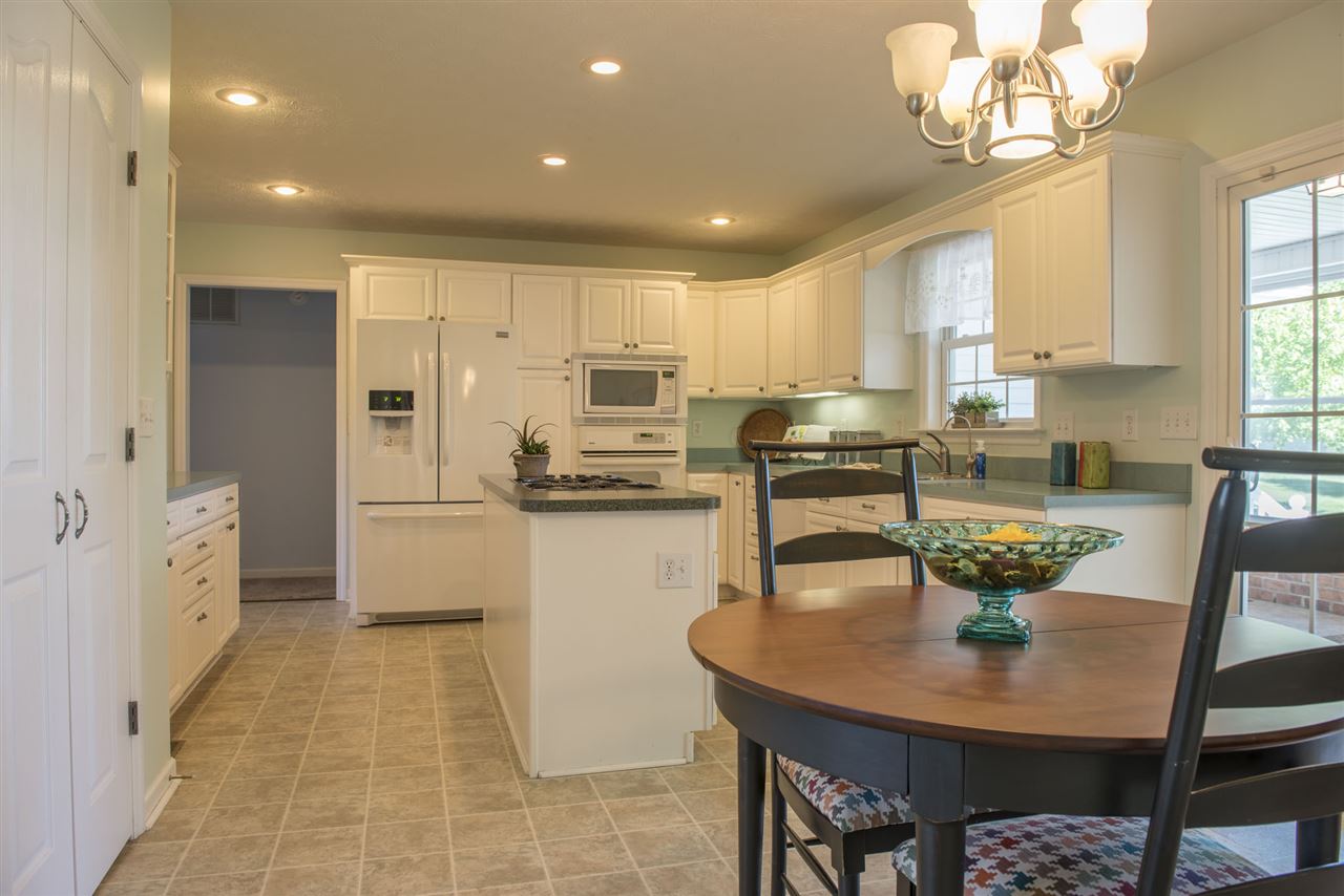 95 Lea Port Road Mount Sidney, VA 24467 - Photo 9 of 37 a kitchen with stainless steel appliances granite countertop a sink a stove a dining table and chairs