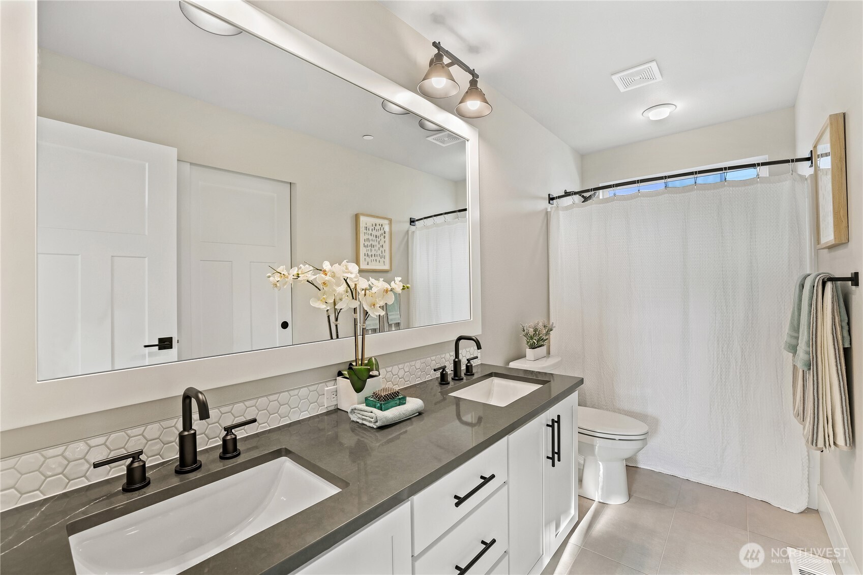 18510 Meridian Avenue Southeast, Unit CR 02 Bothell, WA 98012 - Photo 22 of 31 a bathroom with a double vanity sink and a mirror