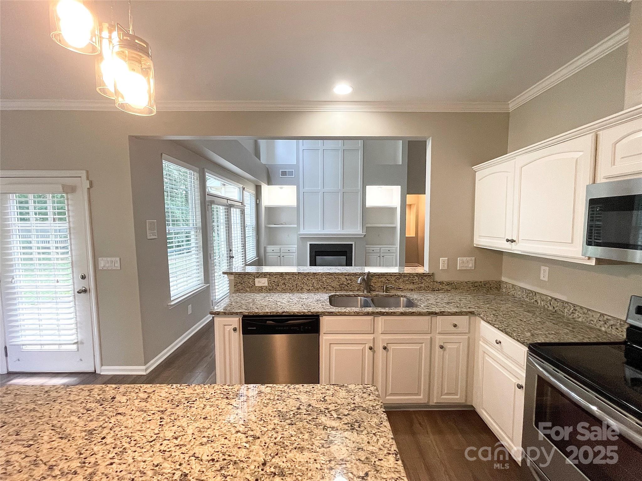 2834 Ritz Lane Matthews, NC 28105 - Photo 11 of 32 a kitchen with granite countertop a sink and a stove