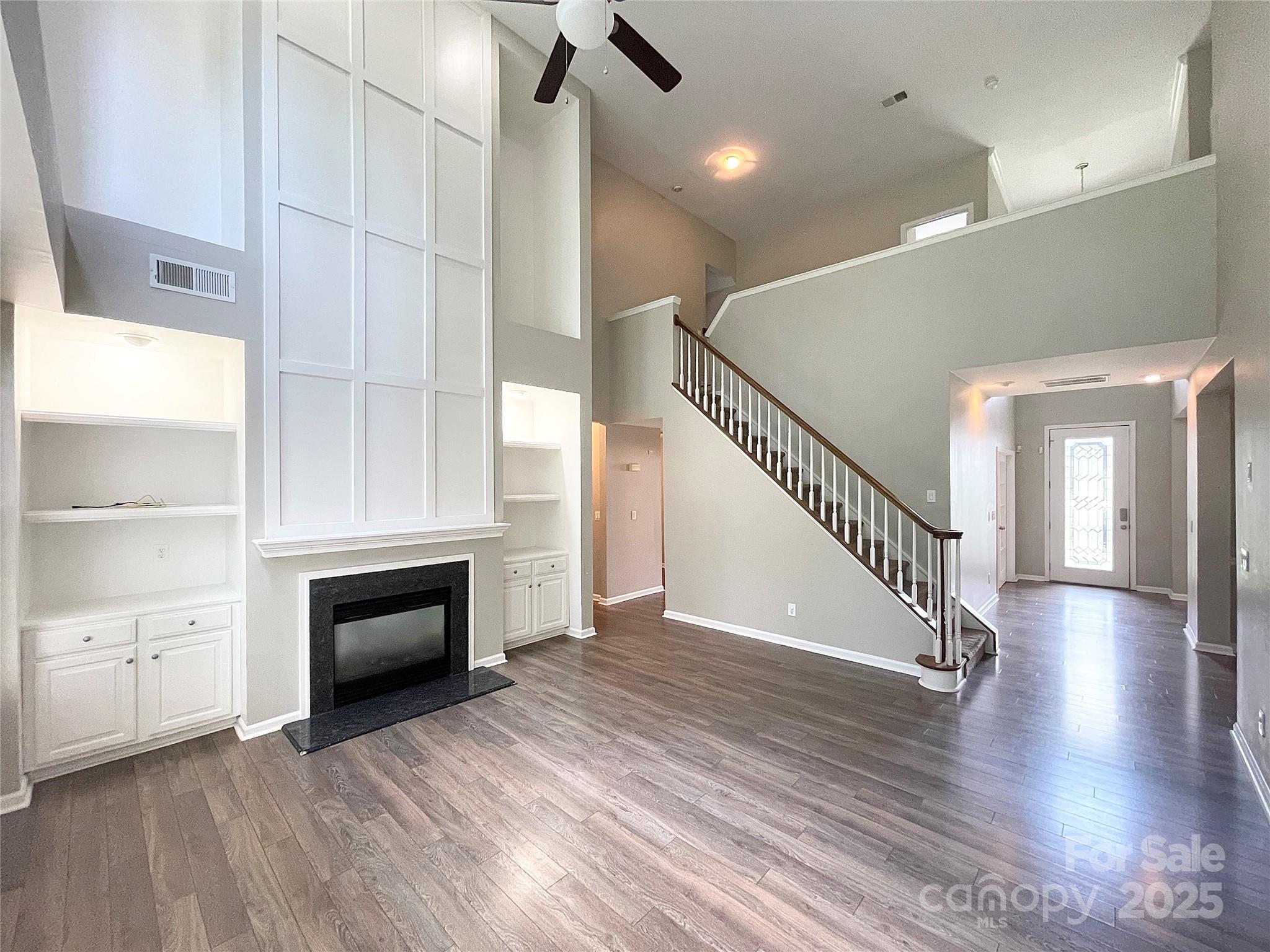 2834 Ritz Lane Matthews, NC 28105 - Photo 12 of 32 a view of an empty room with a kitchen and a fireplace