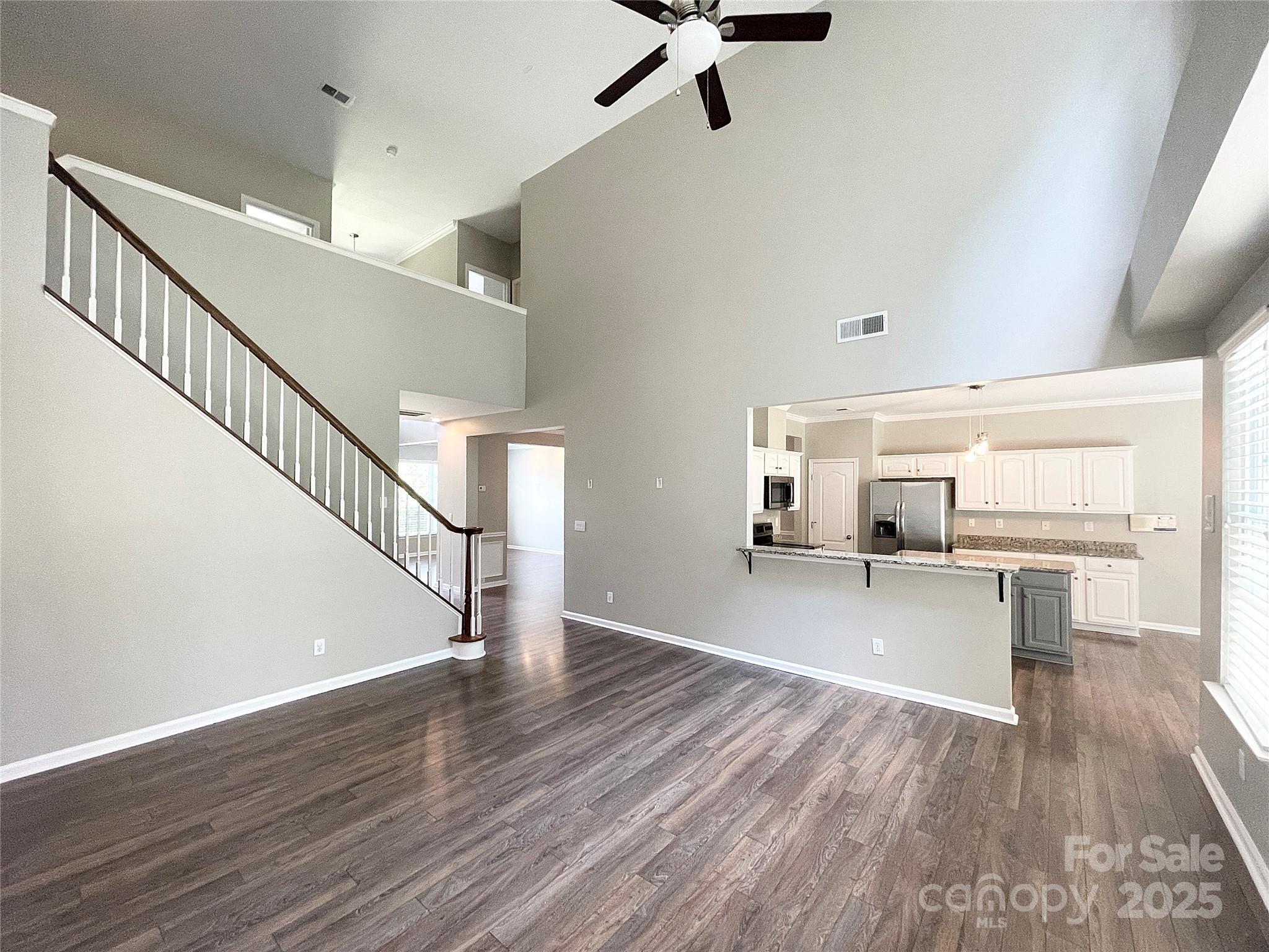 2834 Ritz Lane Matthews, NC 28105 - Photo 14 of 32 a view of a room with wooden floor and staircase