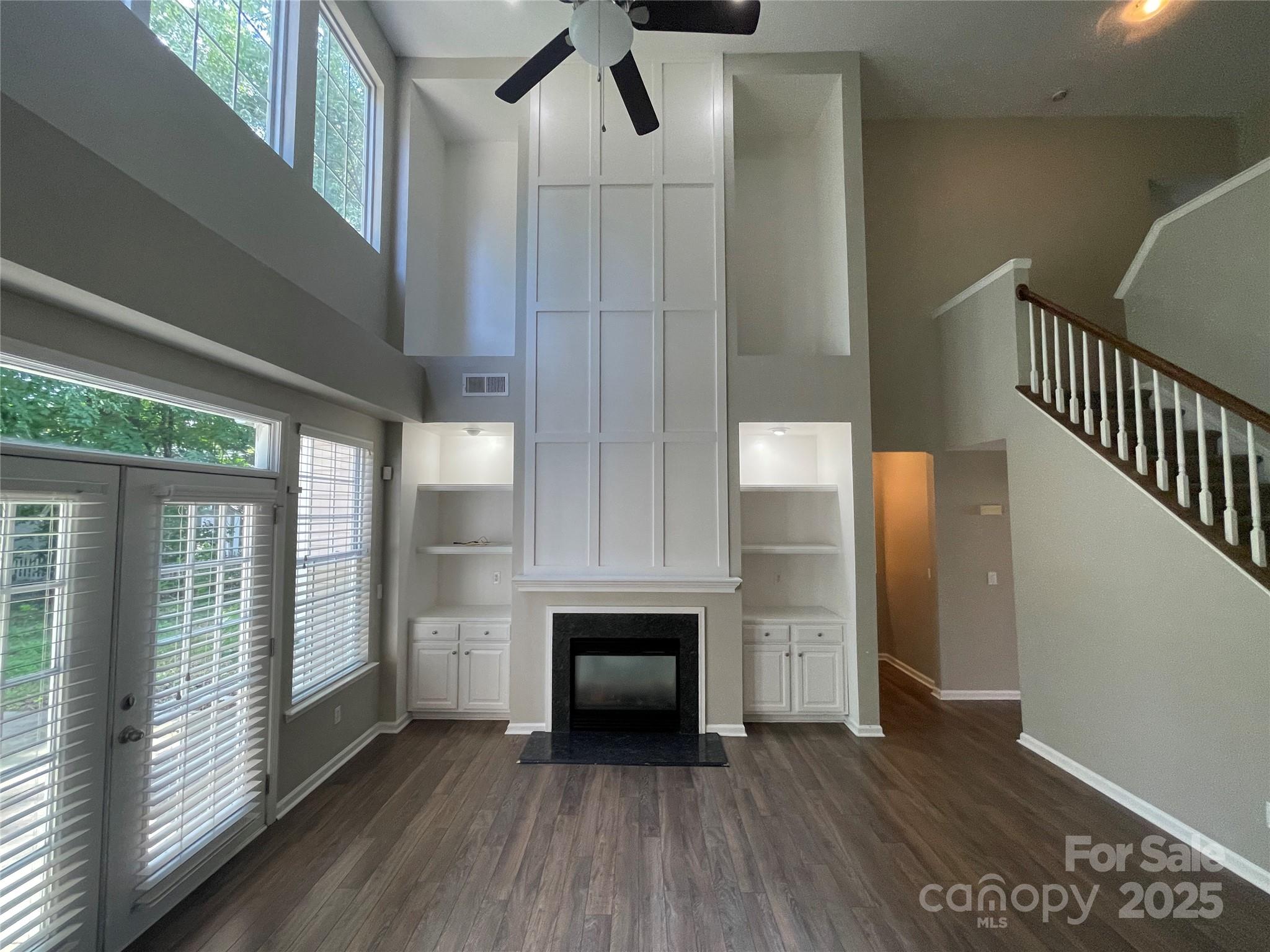 2834 Ritz Lane Matthews, NC 28105 - Photo 15 of 32 a view of a livingroom with wooden floor and staircase