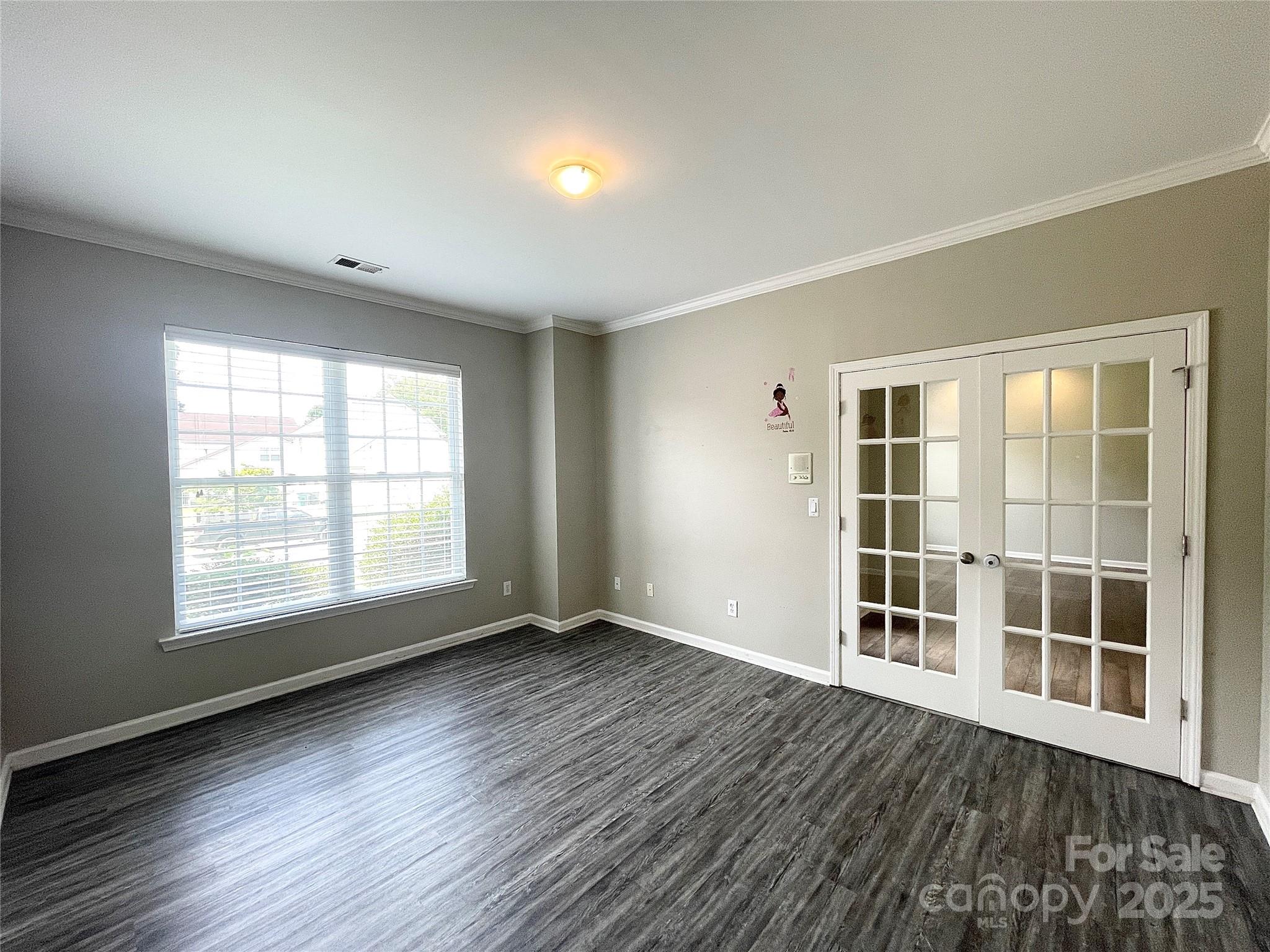 2834 Ritz Lane Matthews, NC 28105 - Photo 20 of 32 an empty room with wooden floor and windows