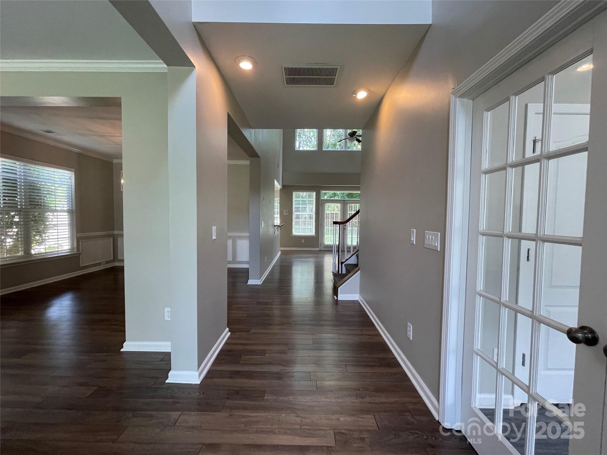 2834 Ritz Lane Matthews, NC 28105 - Photo 2 of 32 a view of a hallway with wooden floor and a living room