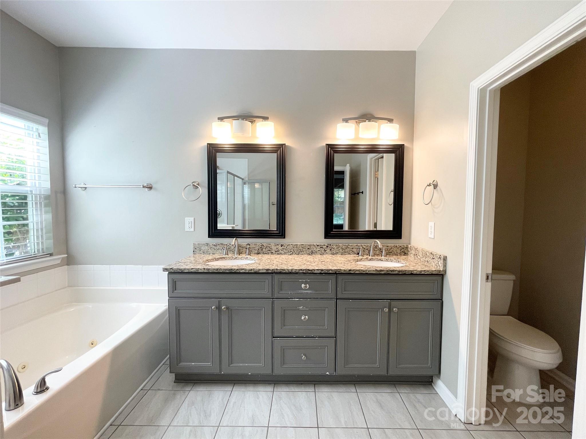 2834 Ritz Lane Matthews, NC 28105 - Photo 23 of 32 a bathroom with a granite countertop sink a toilet and bathtub