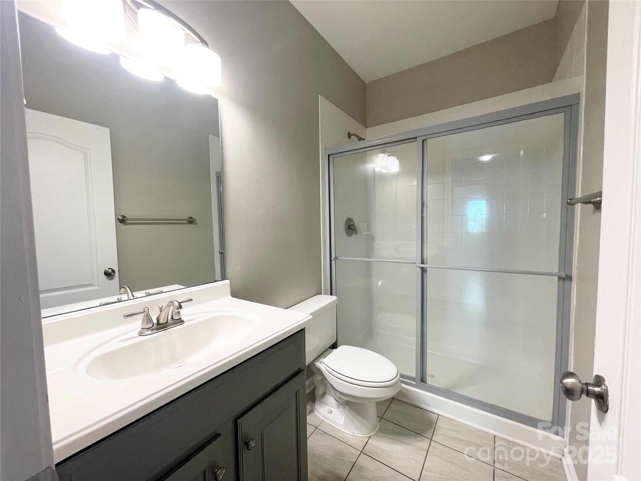 2834 Ritz Lane Matthews, NC 28105 - Photo 29 of 32 a bathroom with a sink a toilet and shower