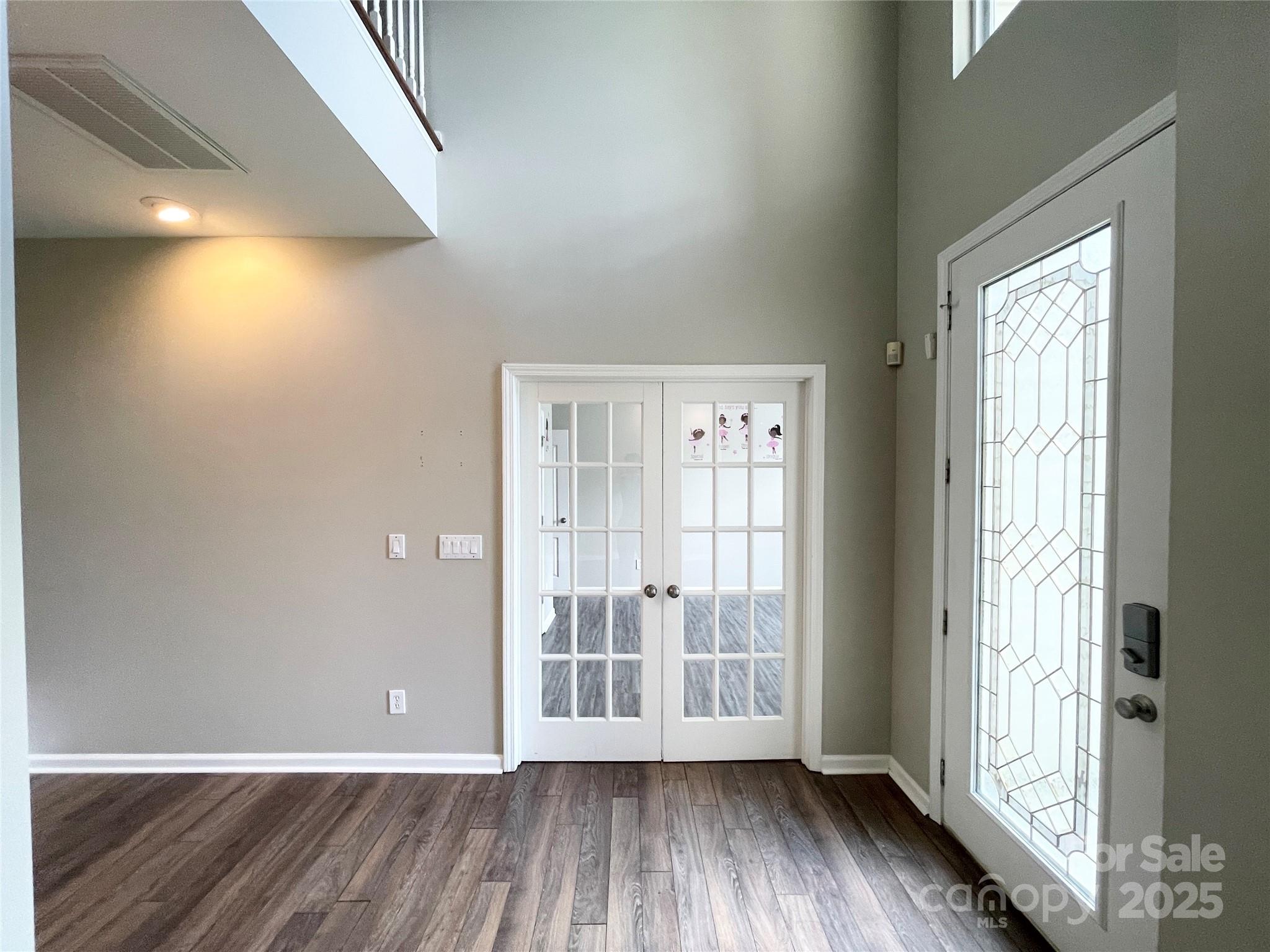2834 Ritz Lane Matthews, NC 28105 - Photo 4 of 32 a view of an empty room with wooden floor and a window