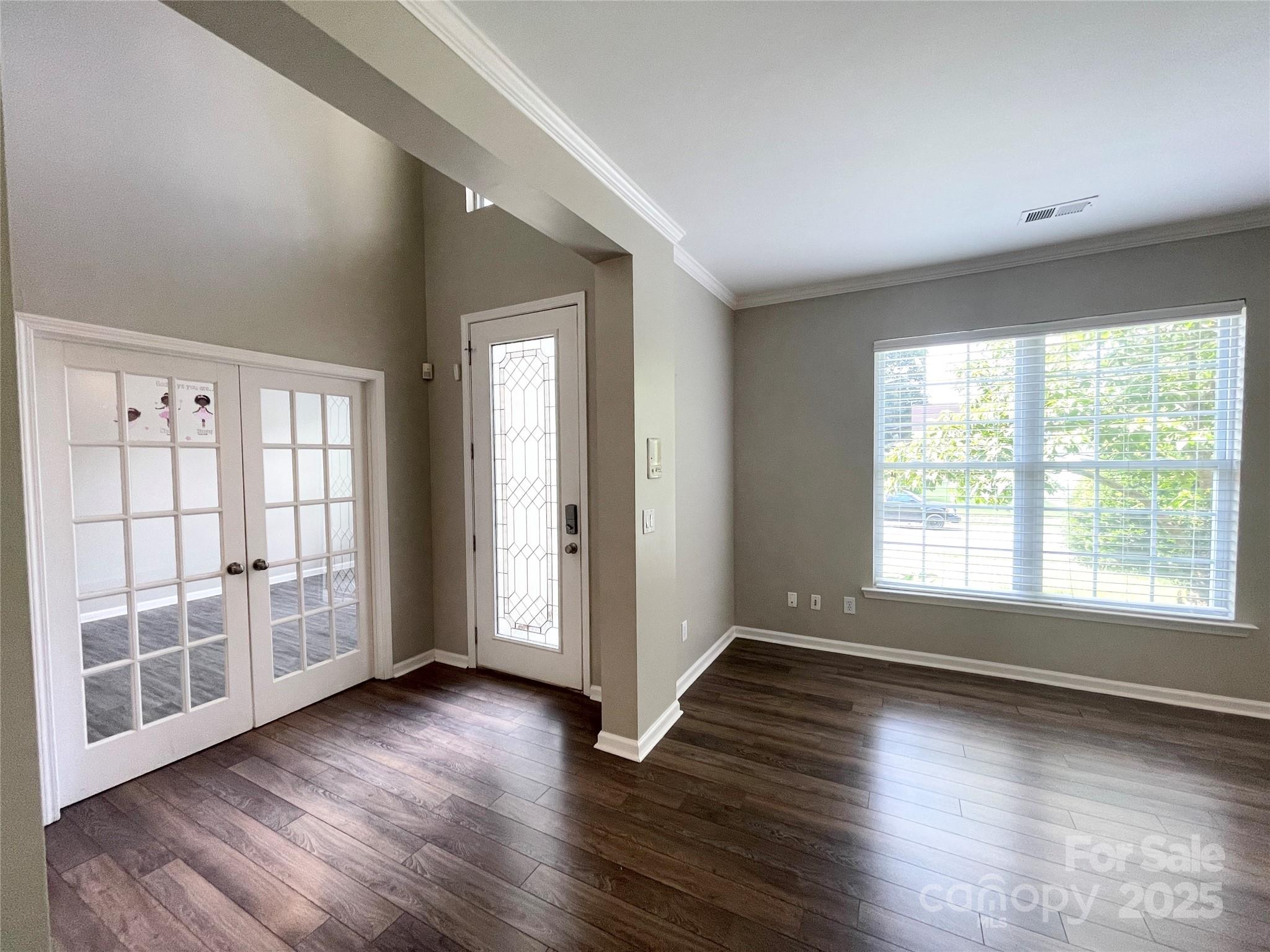 2834 Ritz Lane Matthews, NC 28105 - Photo 5 of 32 a view of an empty room with wooden floor and a window