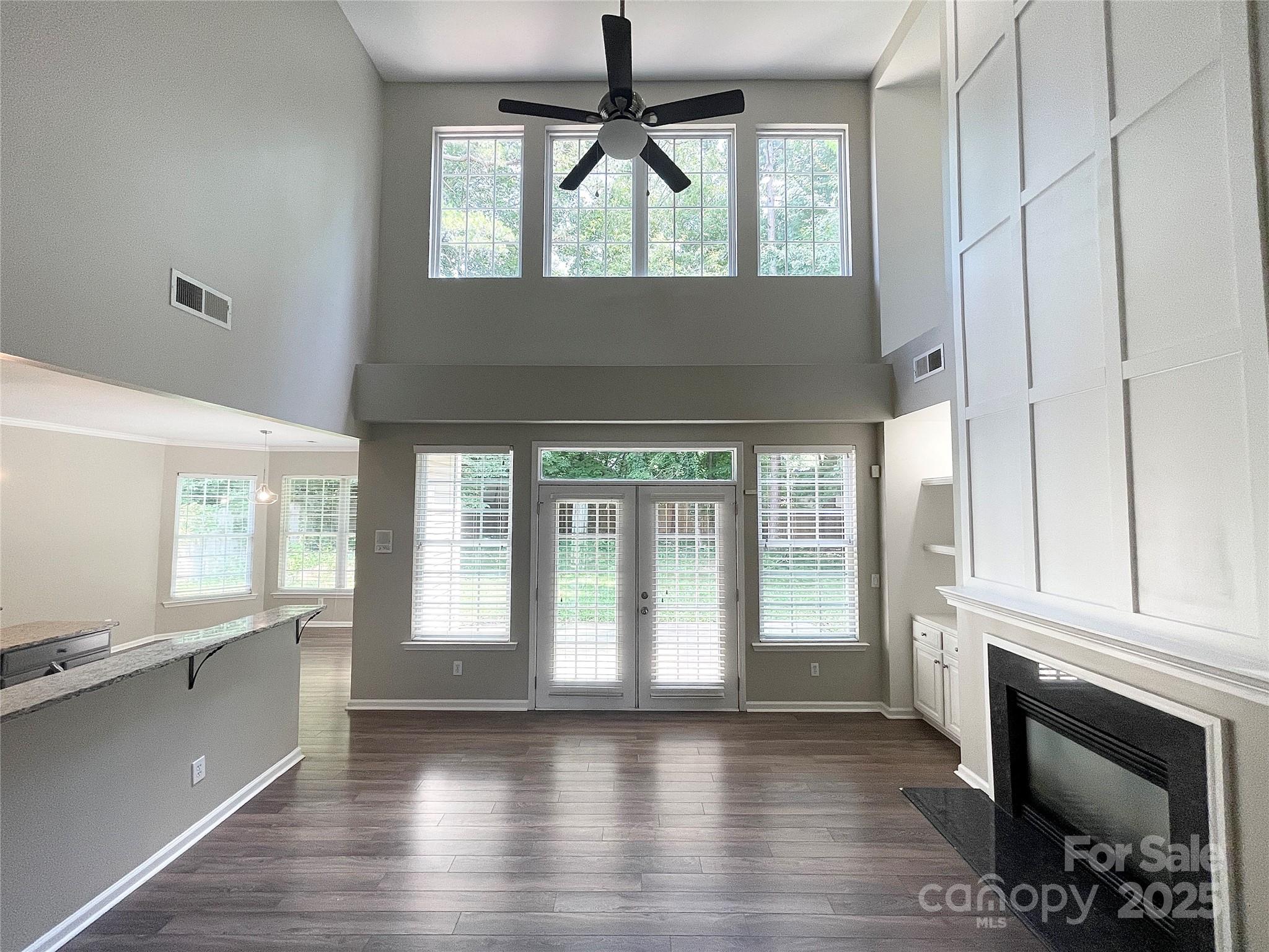 2834 Ritz Lane Matthews, NC 28105 - Photo 7 of 32 a view of an empty room with a window and wooden floor