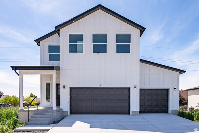 547 North Hvn Drive Mapleton, UT 84664 - Photo 2 of 23 Modern farmhouse exterior featuring white board and batten siding, dark trim, and a two-car garage