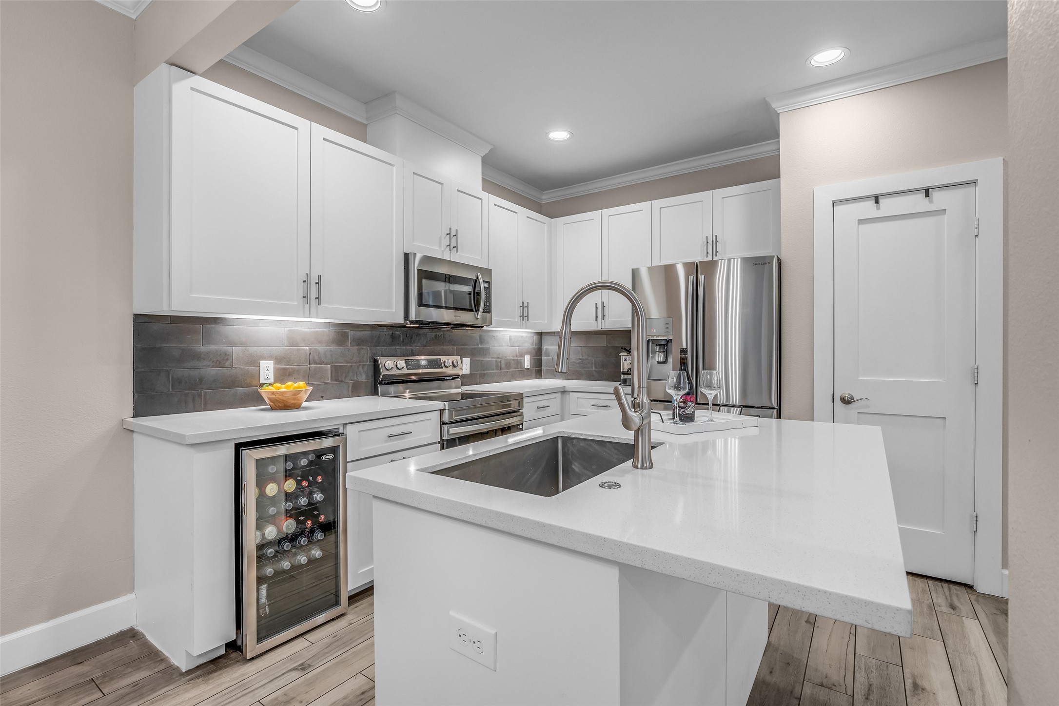 7485 Brompton Street, Unit 7485 Houston, TX 77025 - Photo 5 of 43 Spacious central island provides additional prep space, functionality, and a natural gathering spot for cooking, dining, and entertaining. The thoughtful design enhances both convenience and everyday living.