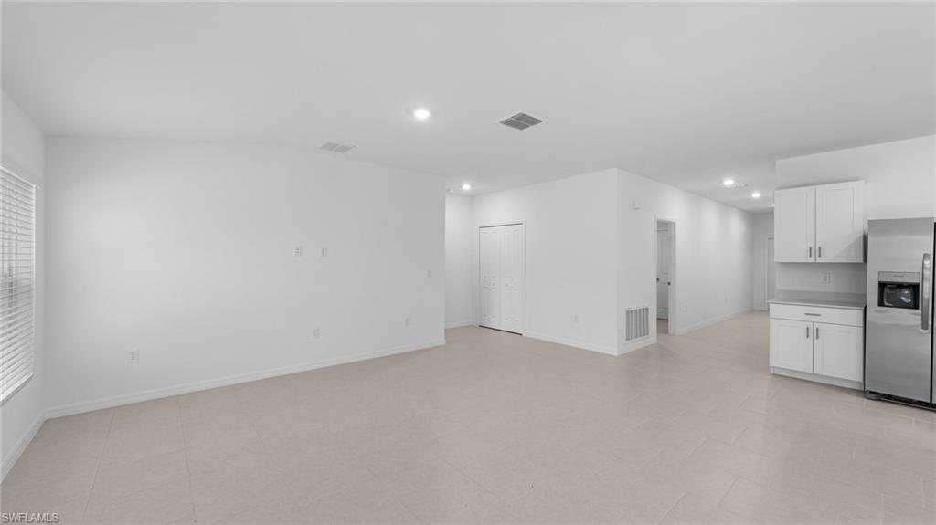 156 Peerless Street Lehigh Acres, FL 33974 - Photo 17 of 26 a view of an empty room with a kitchen
