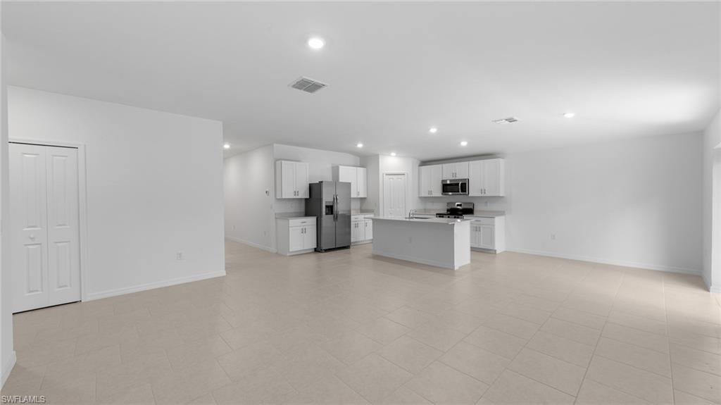 156 Peerless Street Lehigh Acres, FL 33974 - Photo 18 of 26 a view of kitchen with kitchen island and stainless steel appliances