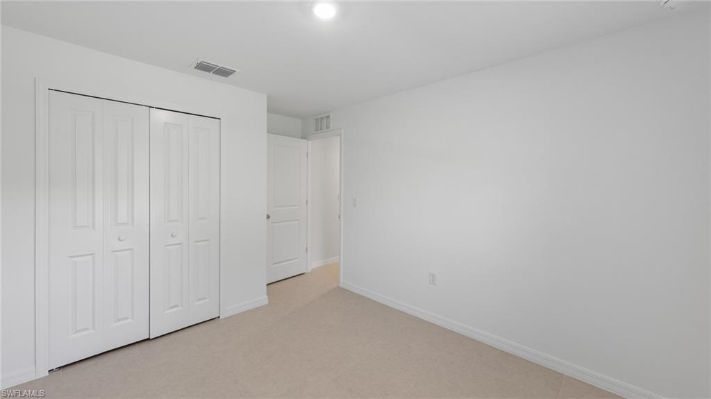 156 Peerless Street Lehigh Acres, FL 33974 - Photo 5 of 26 a view of an empty room