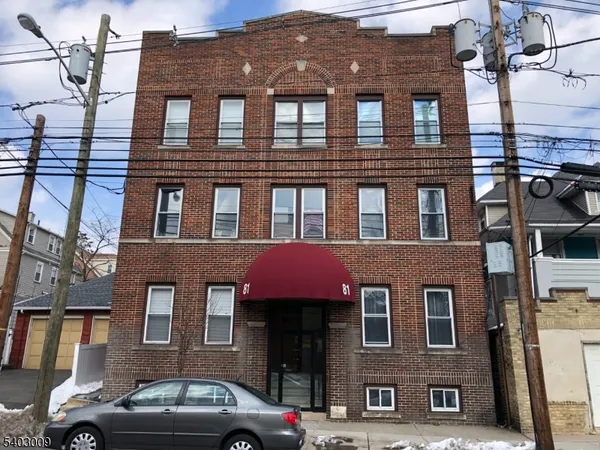 a front view of a building with parking space